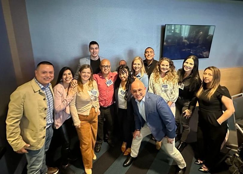 A group of people are posing for a picture in a room.