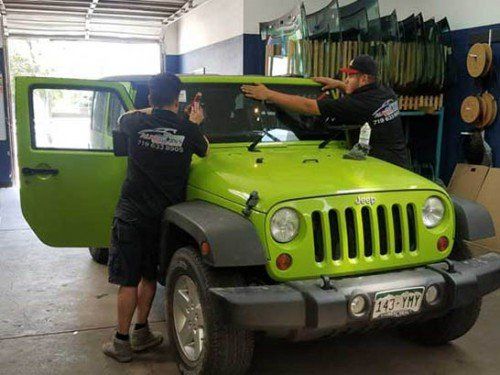 Windshield Replacement — Man repairing car windshield in Colorado Spring, CO