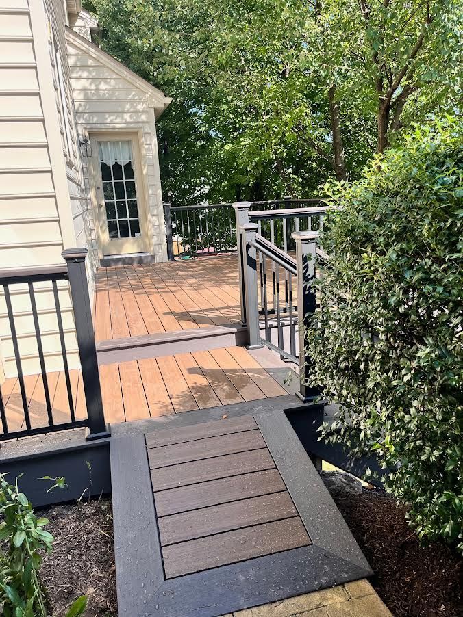 A man is installing a wooden deck with a drill.