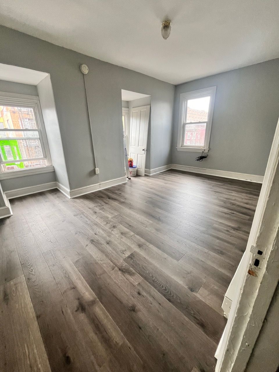 A living room with hardwood floors and gray walls.