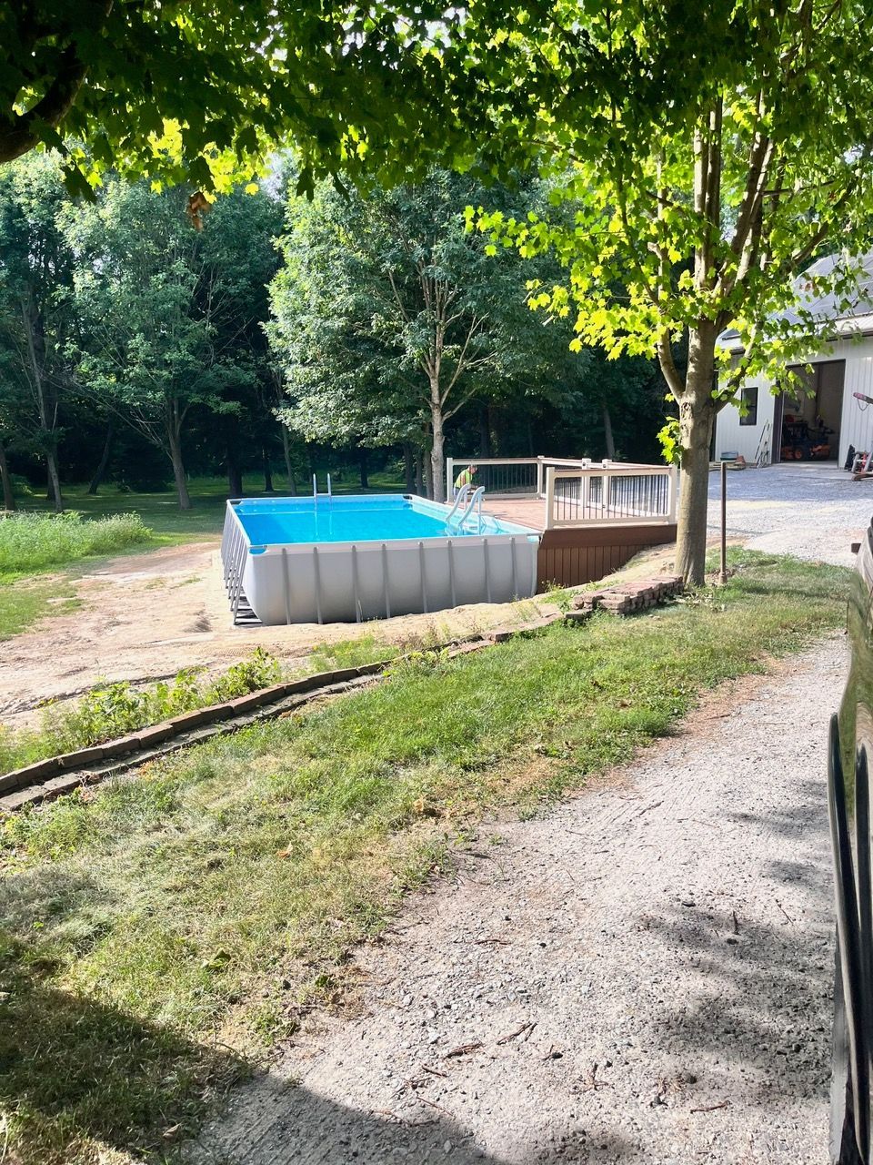 A swimming pool is being built in the backyard of a house.
