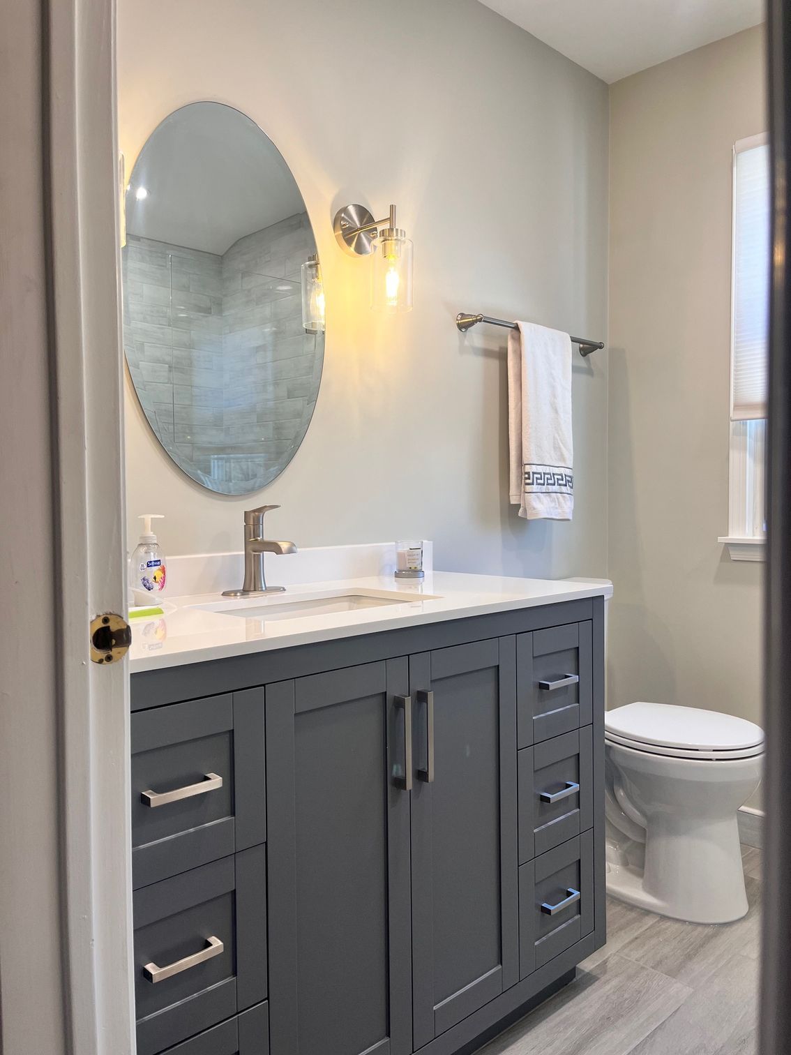 A man is fixing a shower head in a bathroom.