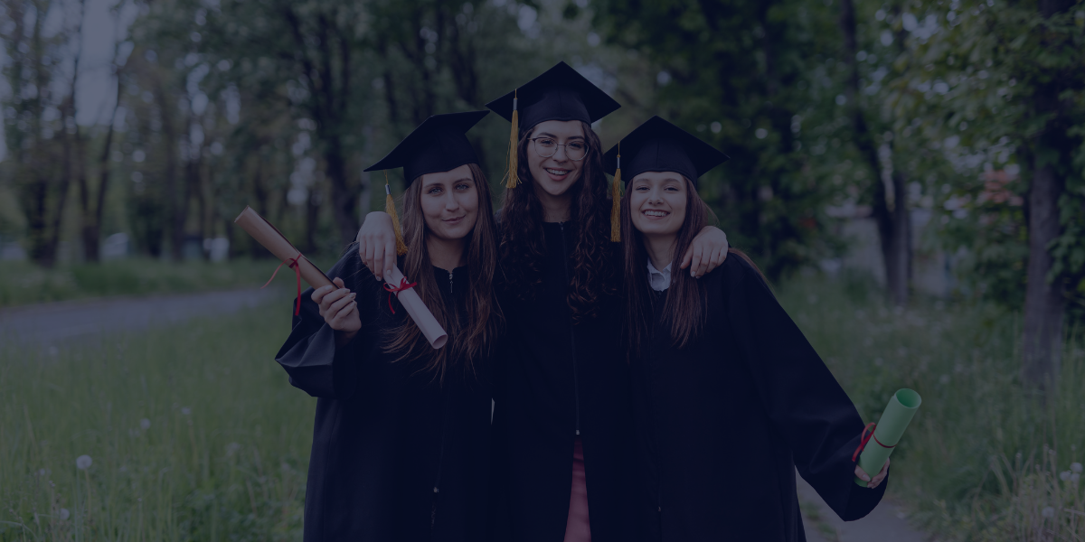 three teenage girls wearing black graduation caps and gowns