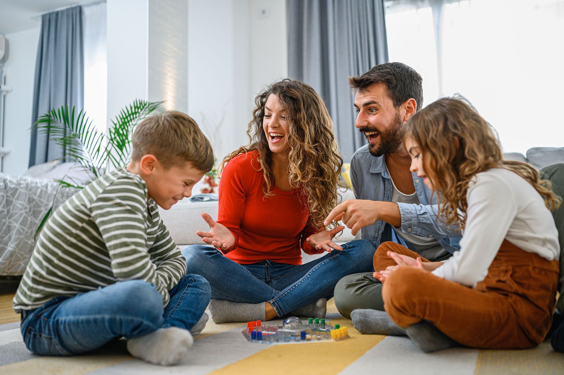 Family Playing Board Game — Baton Rouge, LA — A&K Heating and A/C, Inc.