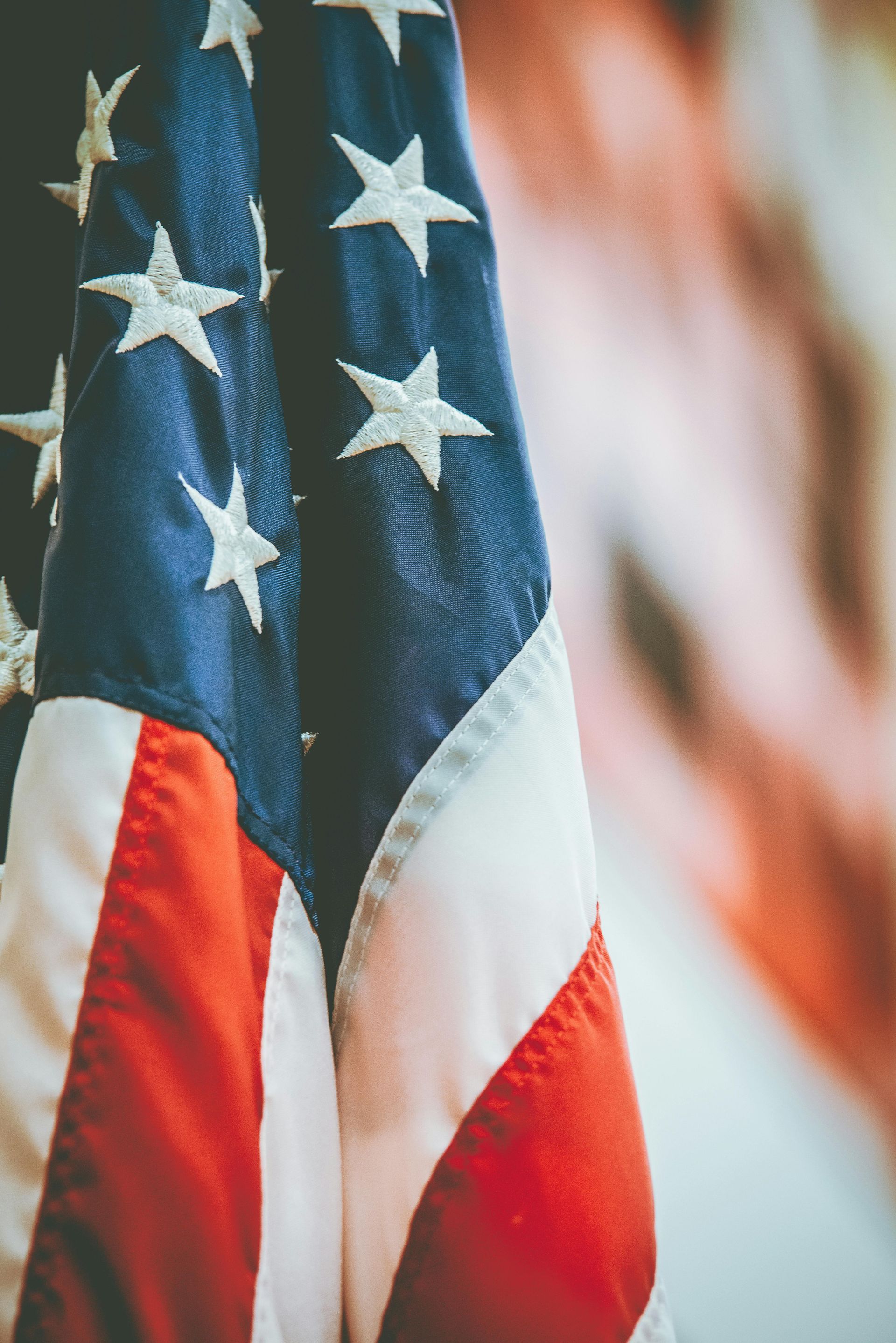 American flag: Blue field with white stars, red and white stripes waving.