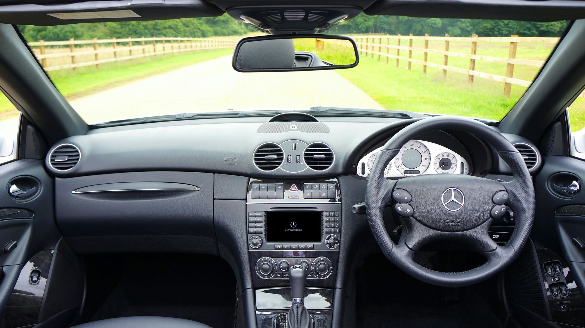 The inside of a car with a steering wheel and dashboard