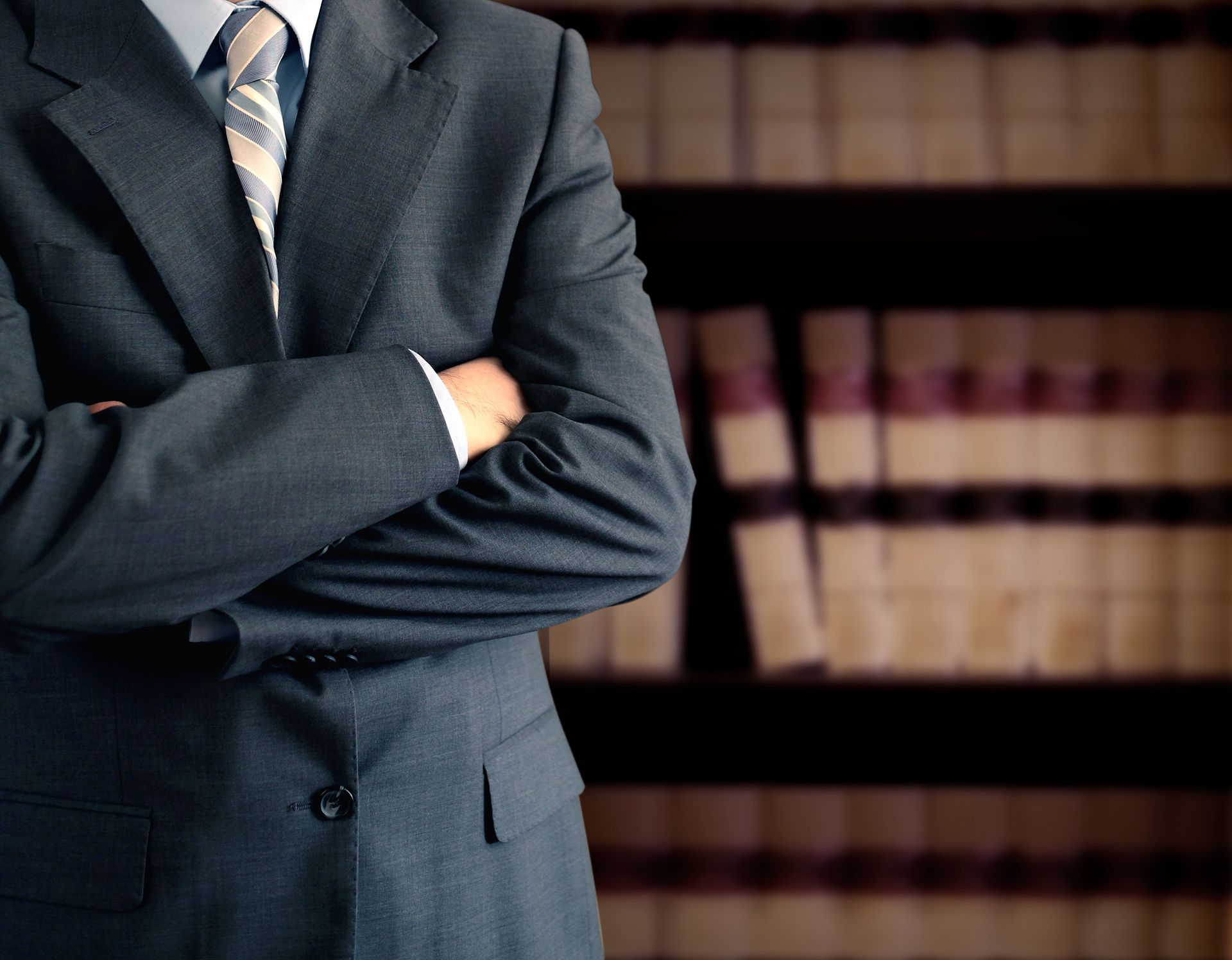 Attorney in office with books representing skilled legal guidance in violent crimes cases defense.