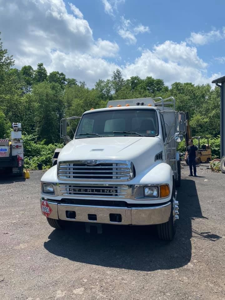 White Sterling truck parked outdoors on a sunny day.