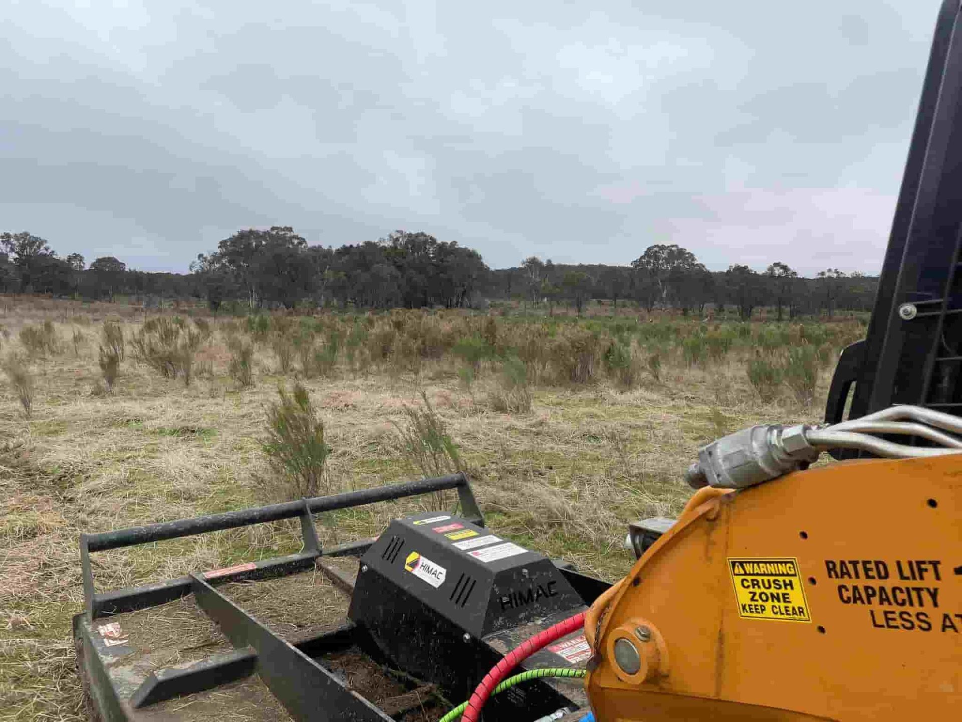 A Grass Trimmer on a Spacious Field  — St Elmo Contracting in Peelwood, NSW