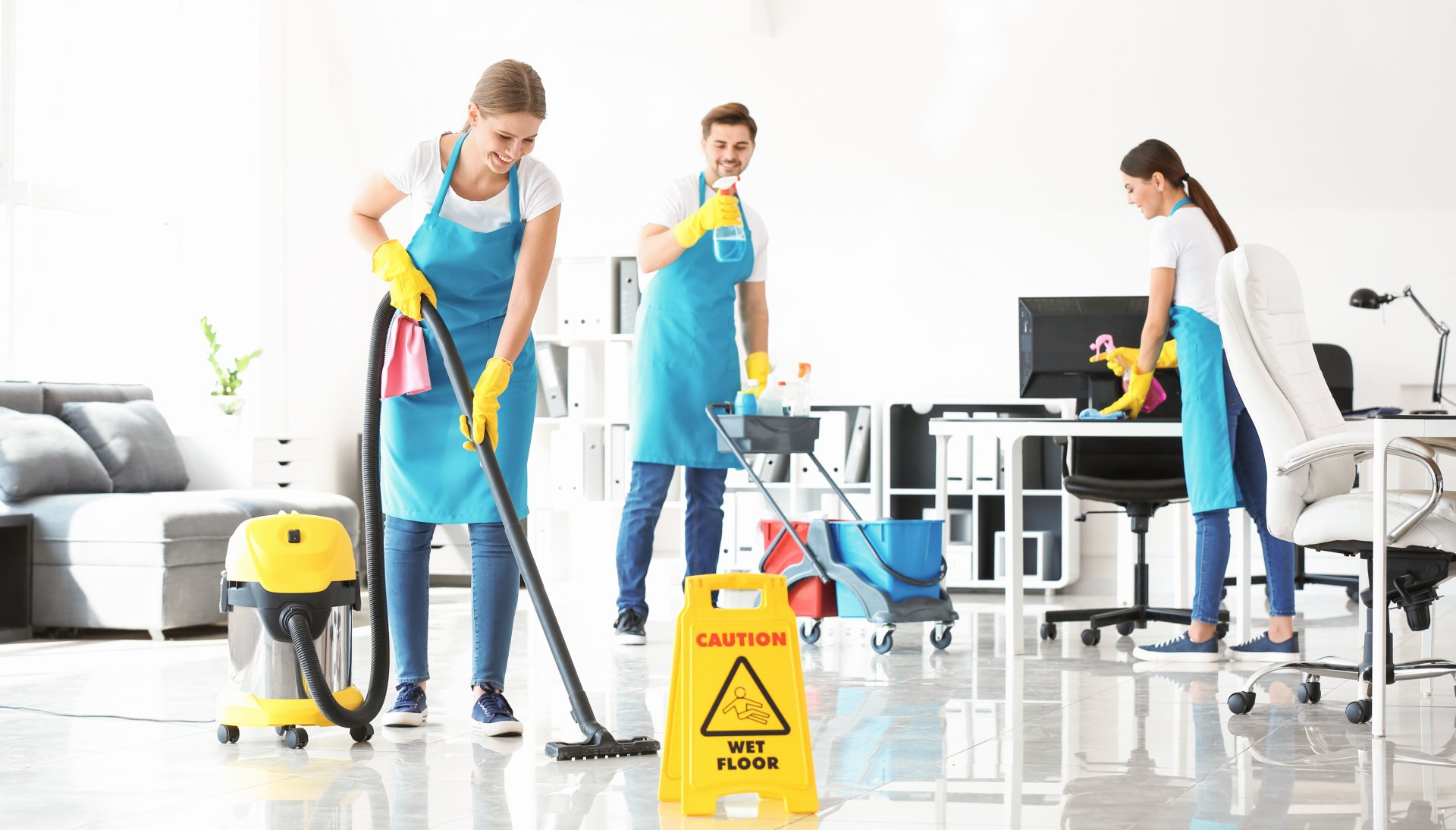 Team of janitors cleaning office