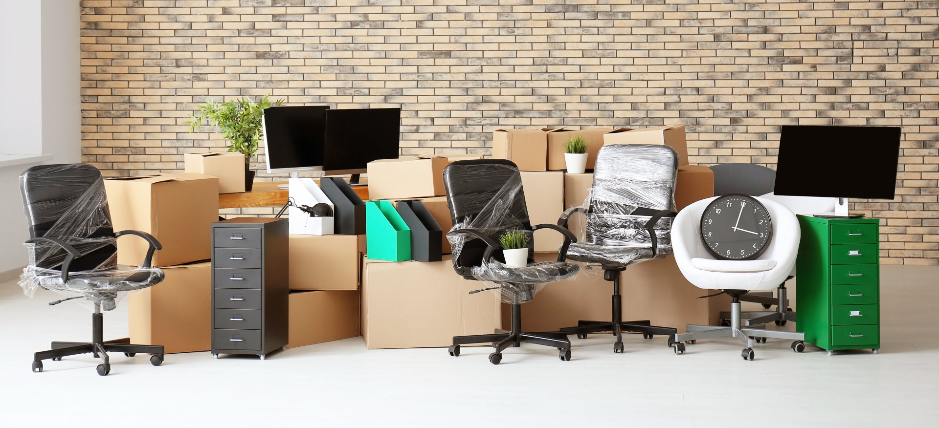 Carton boxes with stuff in empty room.