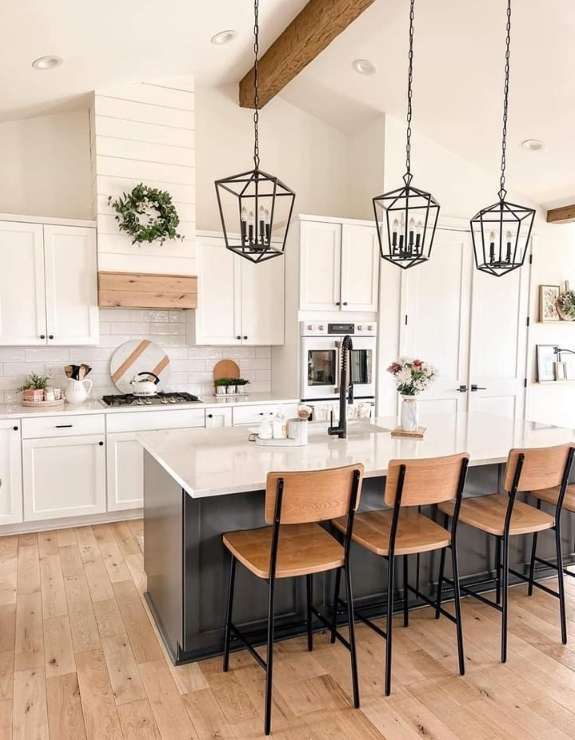 A room under renovation with partially installed dark wood-look plank flooring and exposed subflooring.