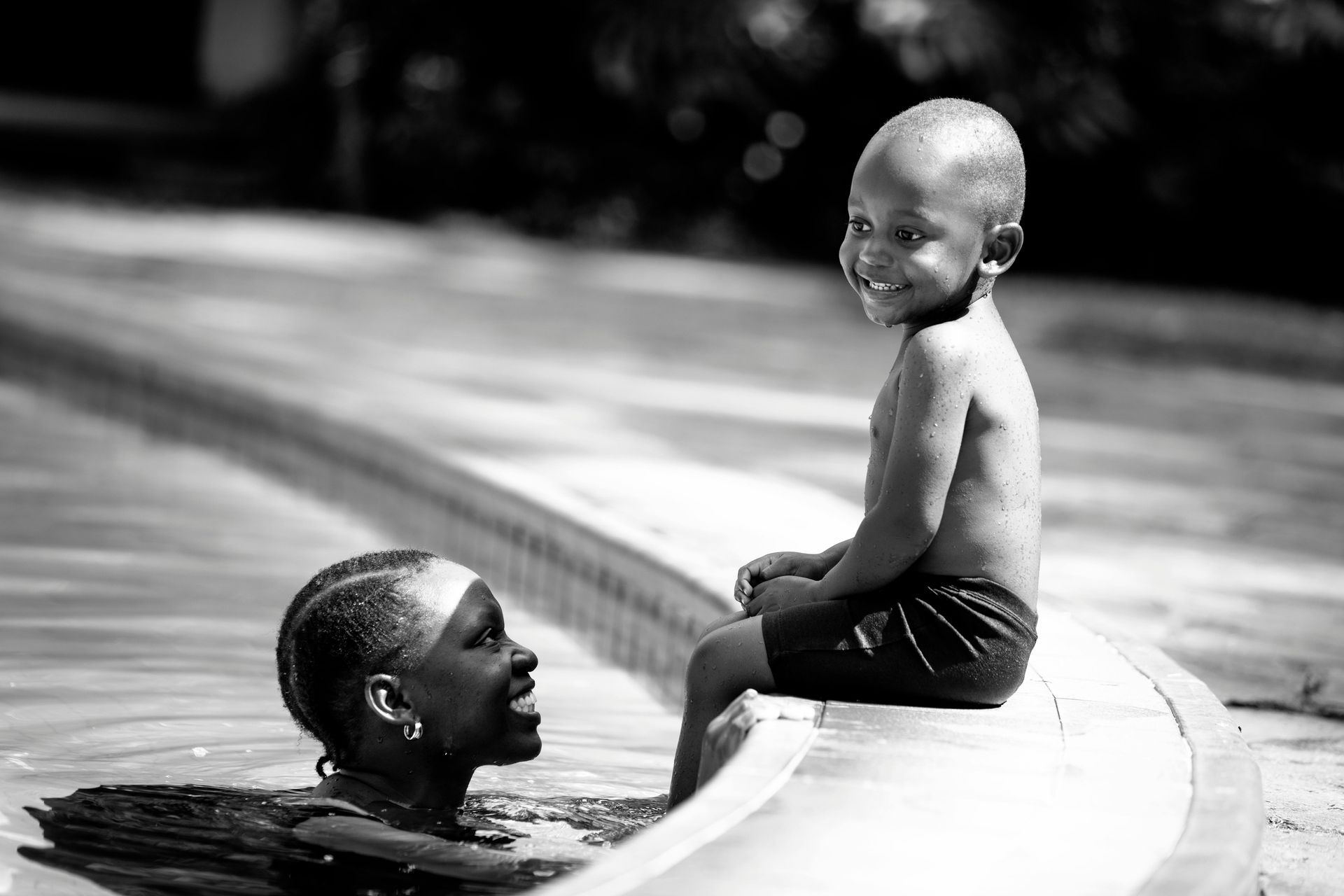 Smiling boy on edge of swimming pool swim lessons in Hampton Roads VA