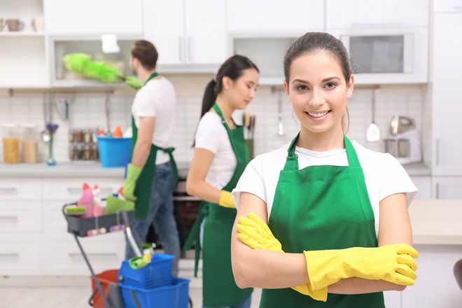 Cleaning service team at work in kitchen