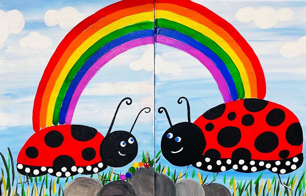 Two ladybugs are standing next to each other under a rainbow.