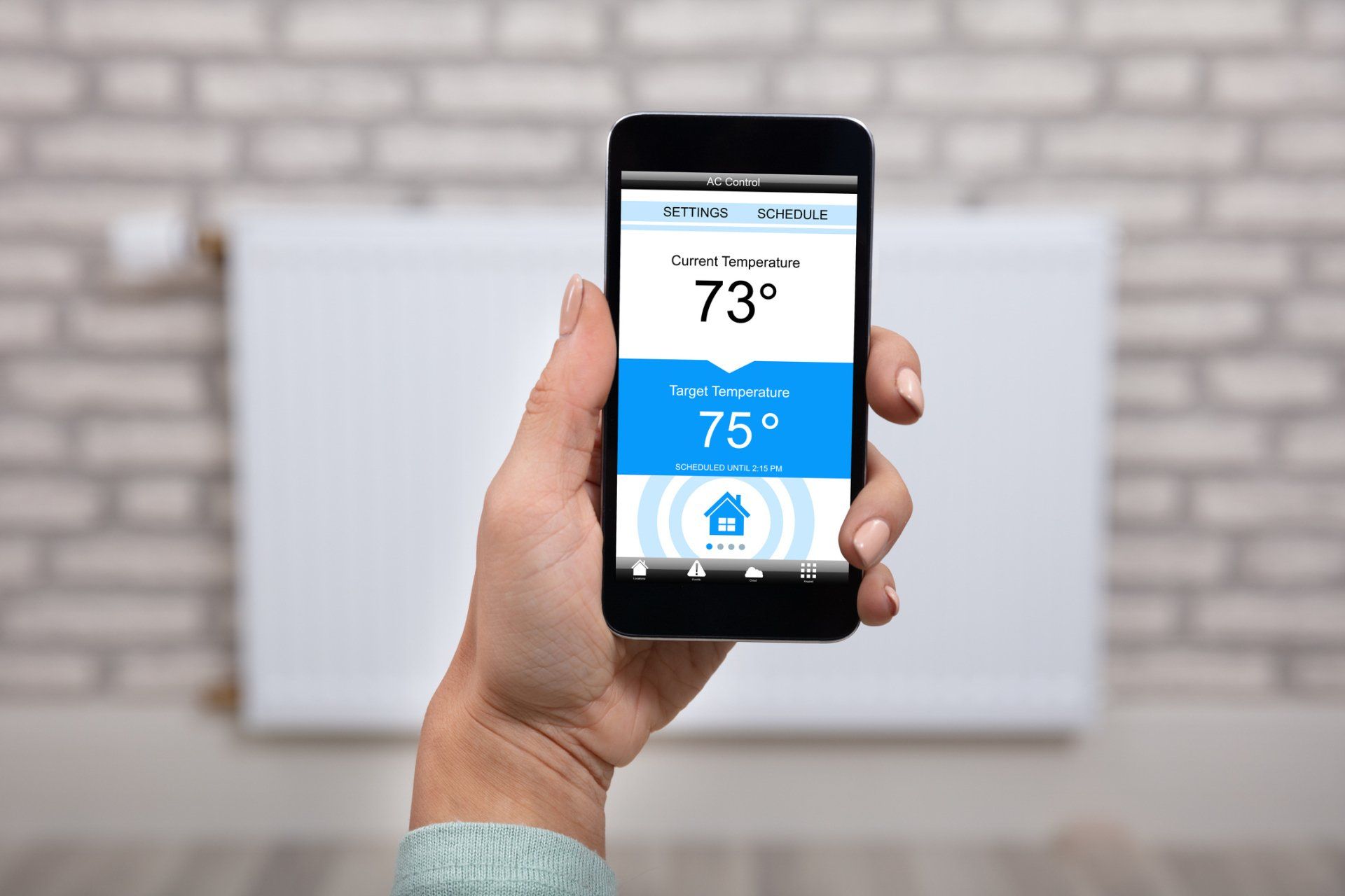 Woman operating thermostat — Toledo, OH — Diamond Heating & Air Conditioning Inc