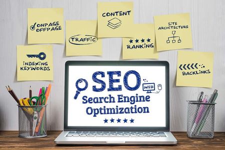 a laptop computer is open to a screen that says seo search engine optimization .
