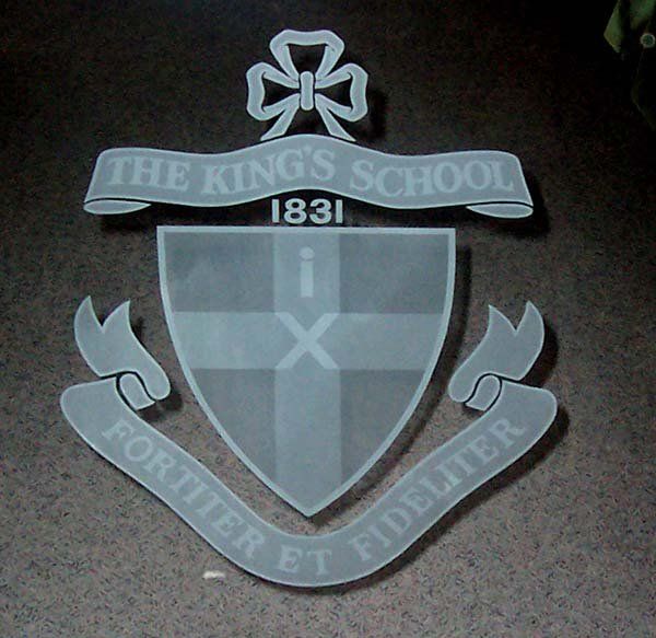 kings school emblem on glass sign