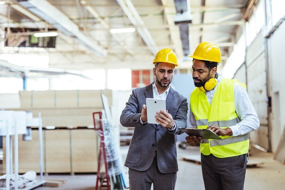 Two professionals wearing safety gear