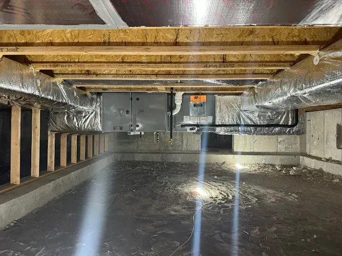 There is a light shining through the ceiling of a basement.