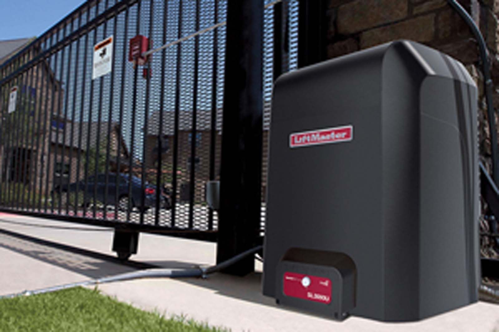A garage door opener is sitting next to a gate.