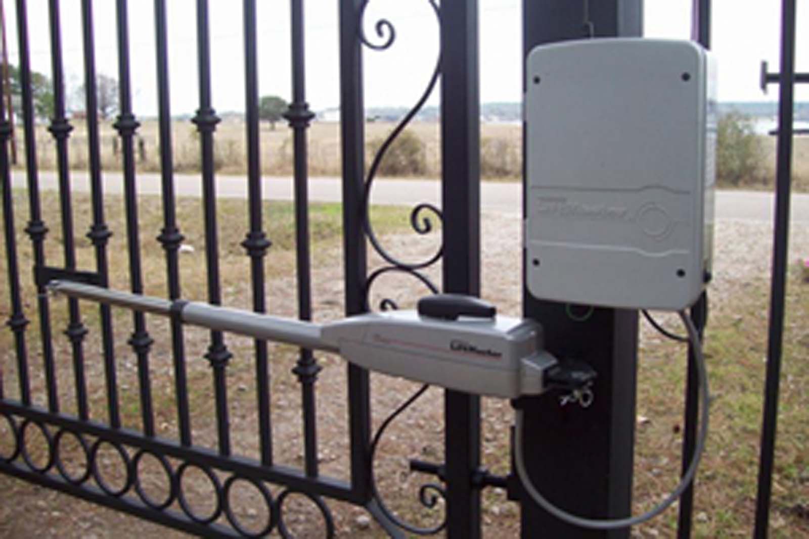 A wrought iron gate with a motor attached to it
