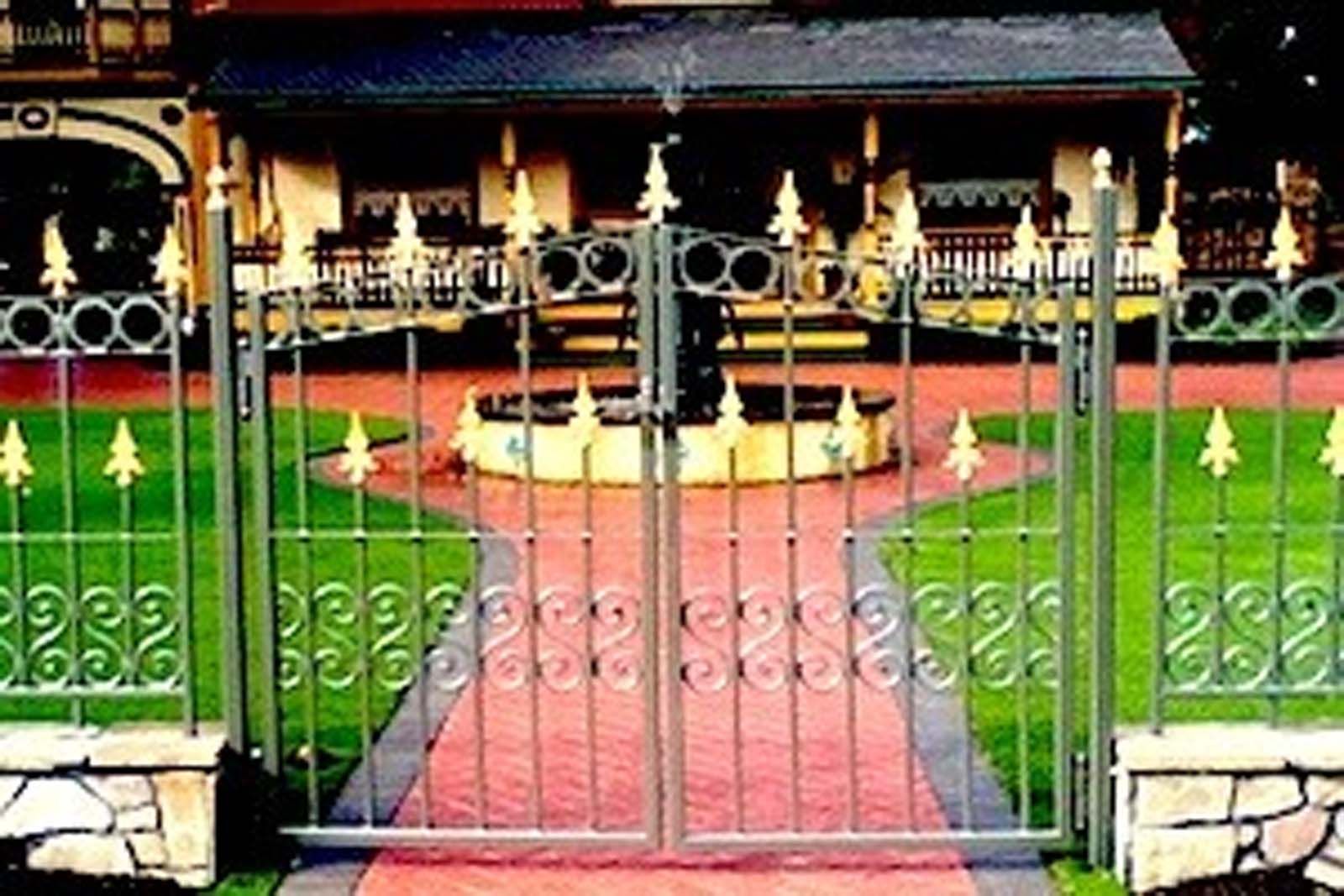 A wrought iron gate in front of a house