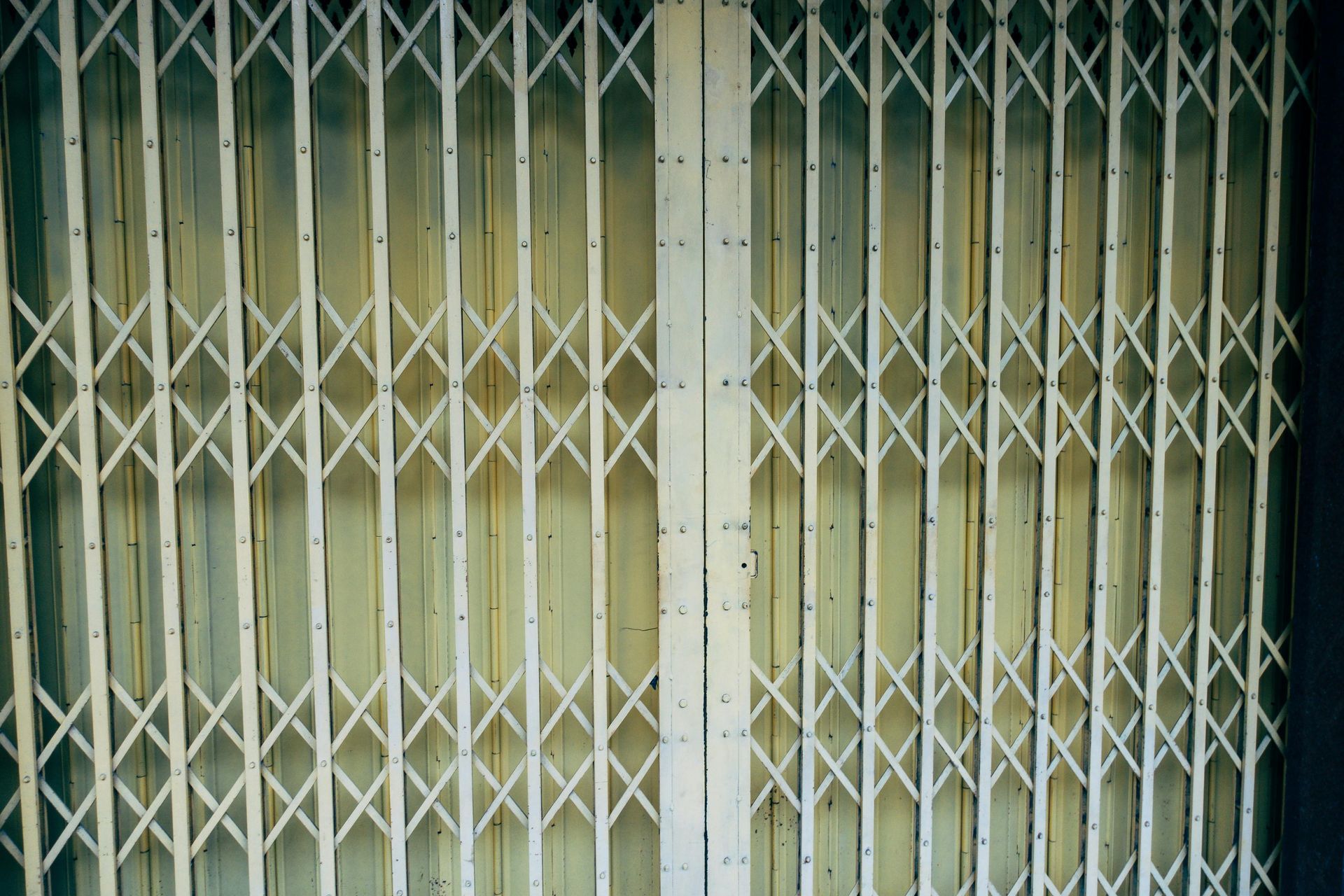 A close up of a white metal gate on a building.