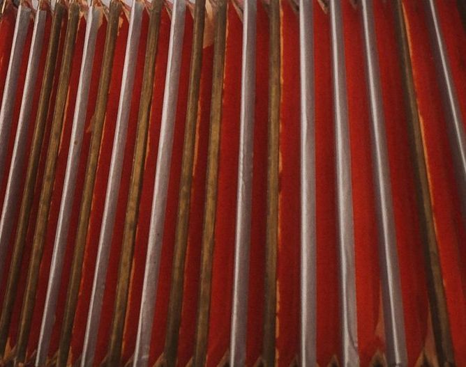 A close up of a red and white pleated curtain