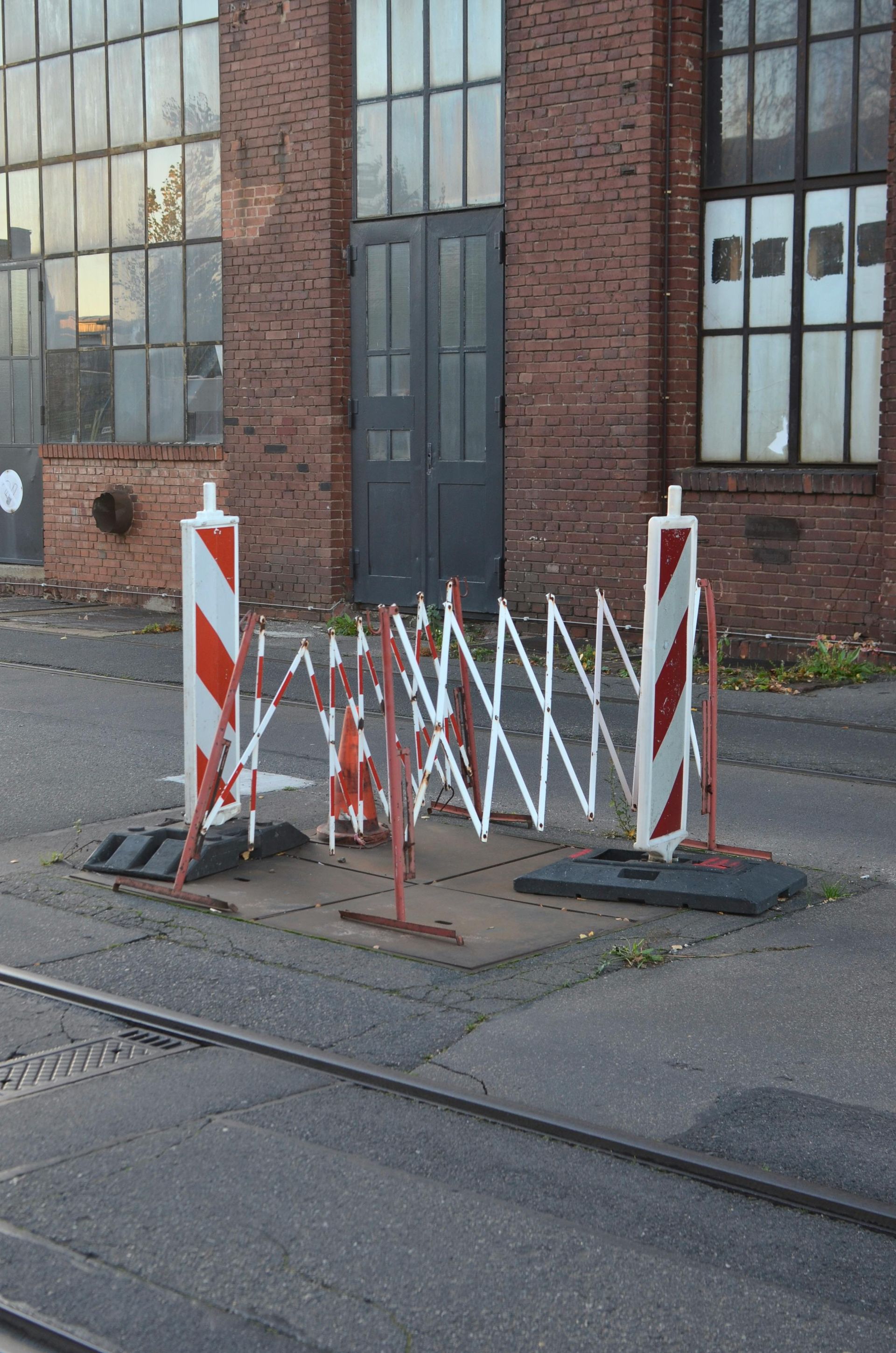 A red and white barrier is sitting on the side of the road