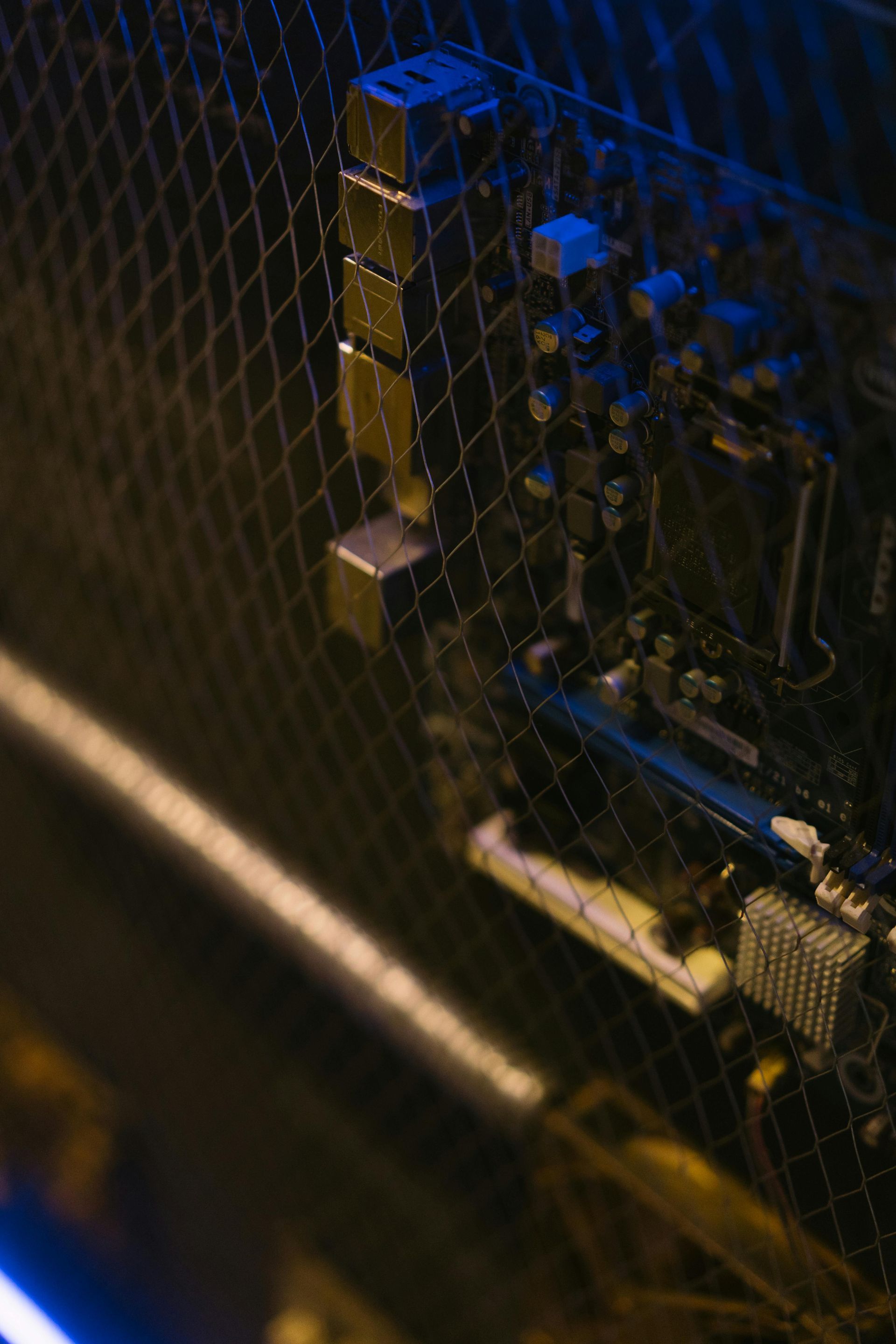 A close up of a computer motherboard in a dark room.