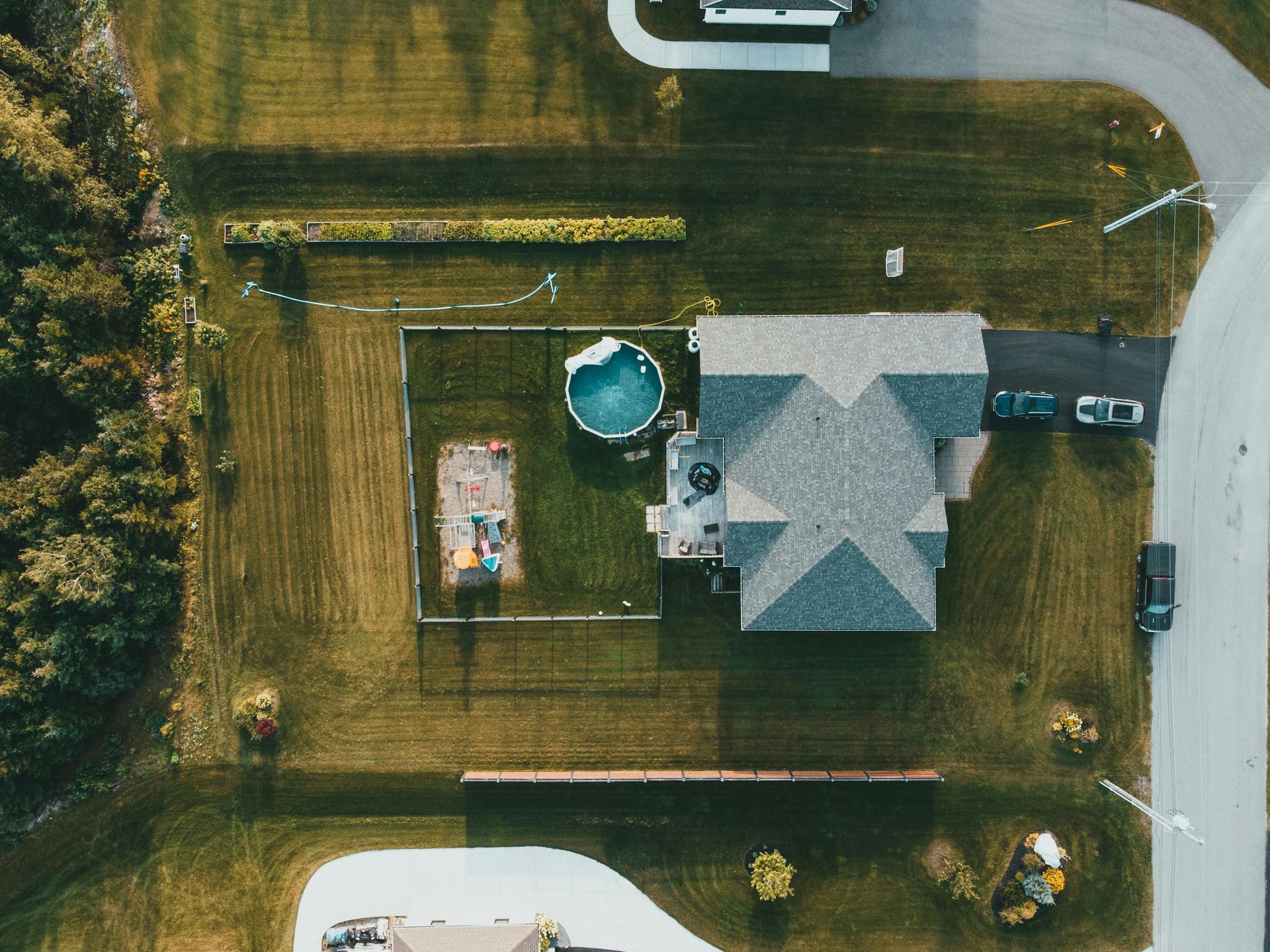 An aerial view of a house with a pool in the backyard