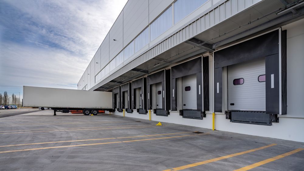 A truck is loading cargo into a warehouse.