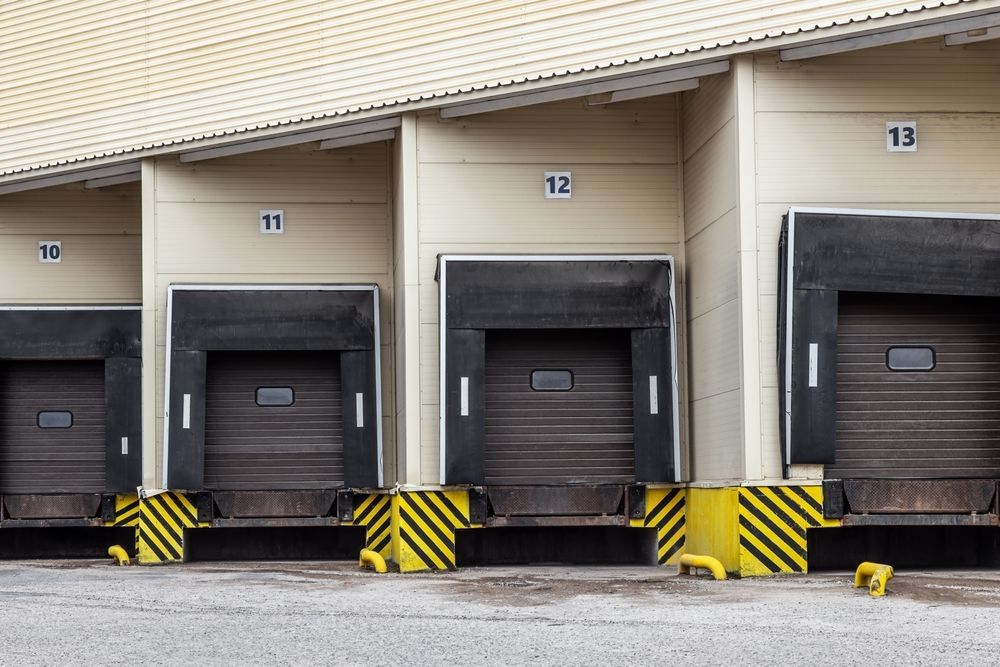 A row of loading docks in a warehouse with numbers on them.
