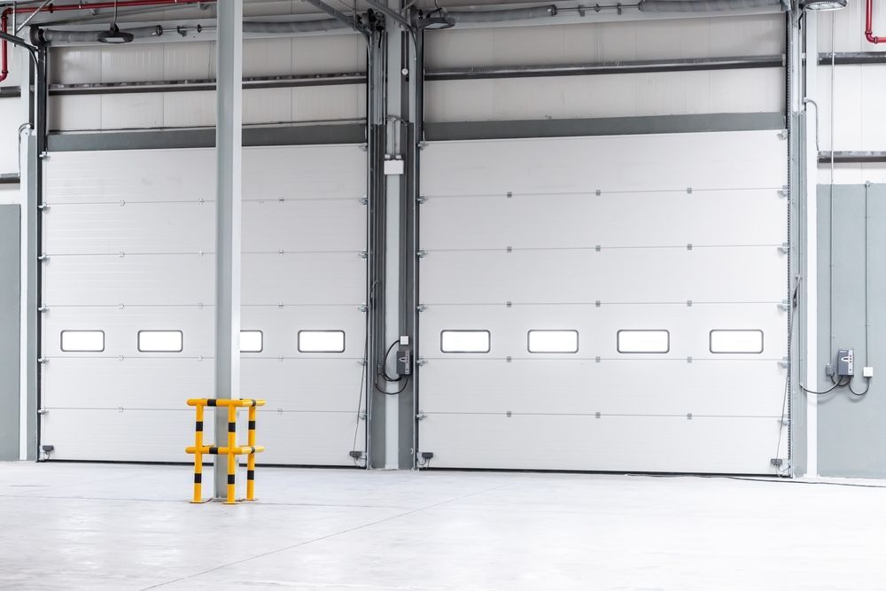 An empty warehouse with a lot of white doors