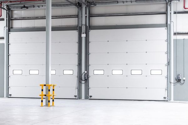 An empty warehouse with a lot of white doors