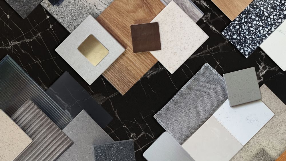 There are many different types of tiles and marbles on the table.