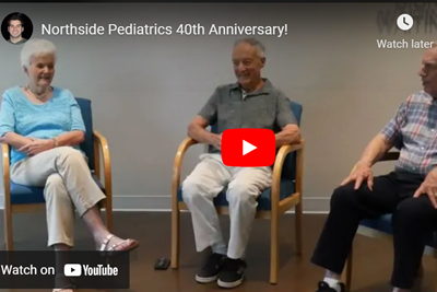 Three people seated in chairs, celebrating Northside Pediatrics 40th anniversary.