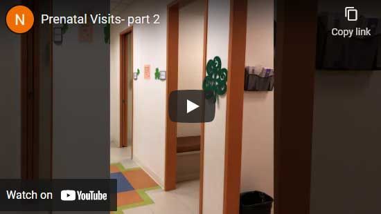 Hallway with open doorways at a medical facility. The video title is