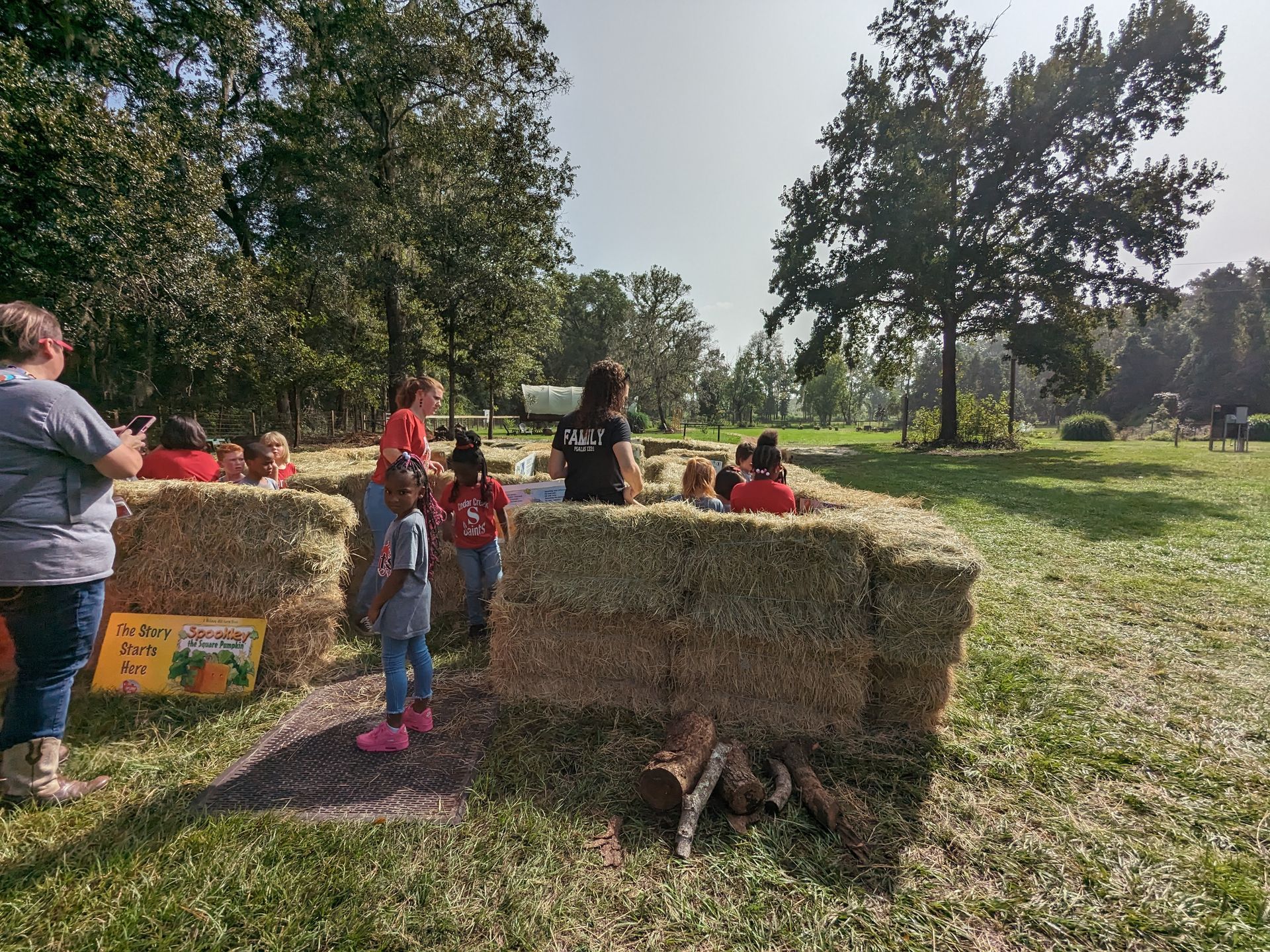Children in a hay bale maze on a sunny day at an outdoor event in a Florida animal farm