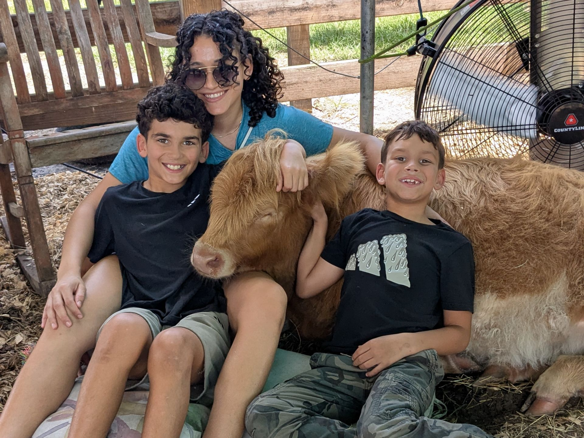 2 boys and a woman cow cuddling in Melrose, FL
