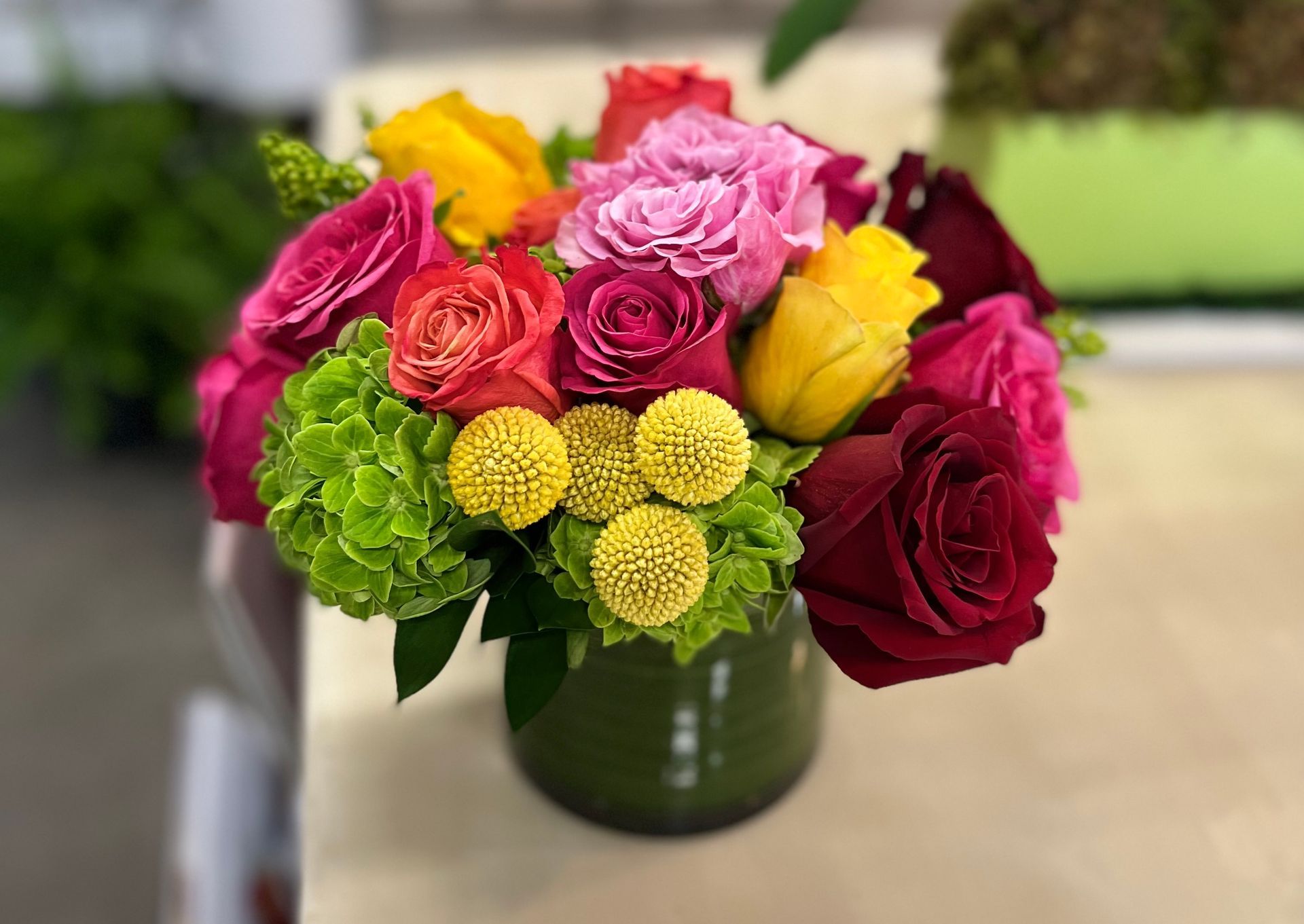 A vase filled with colorful flowers is sitting on a table.