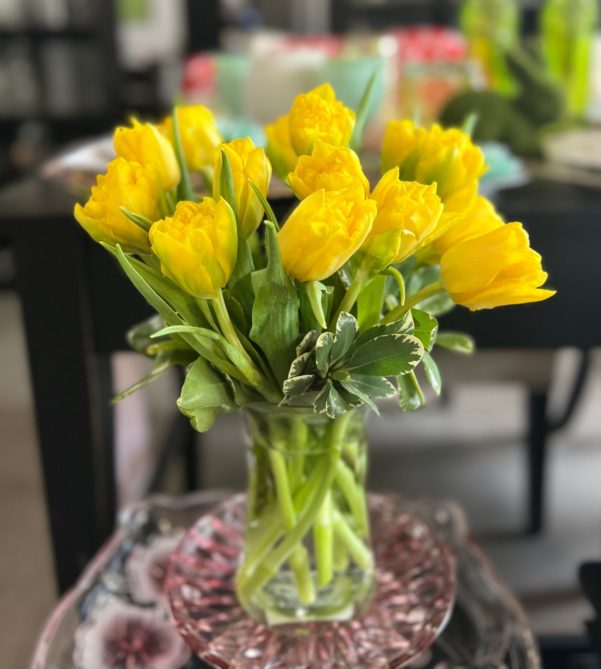 A vase filled with yellow flowers sits on a table
