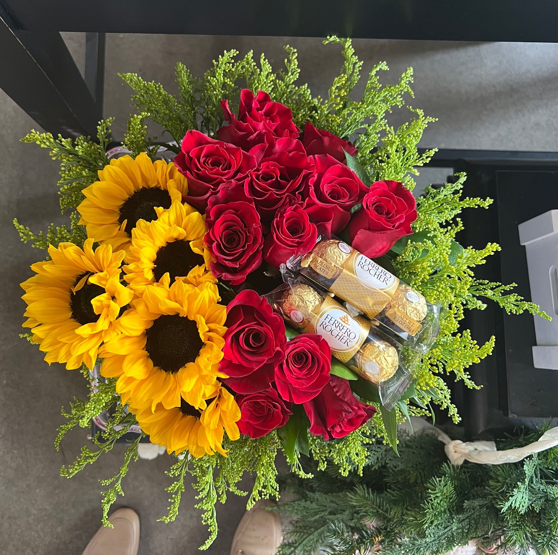 A bouquet of sunflowers and red roses with ferrero rocher