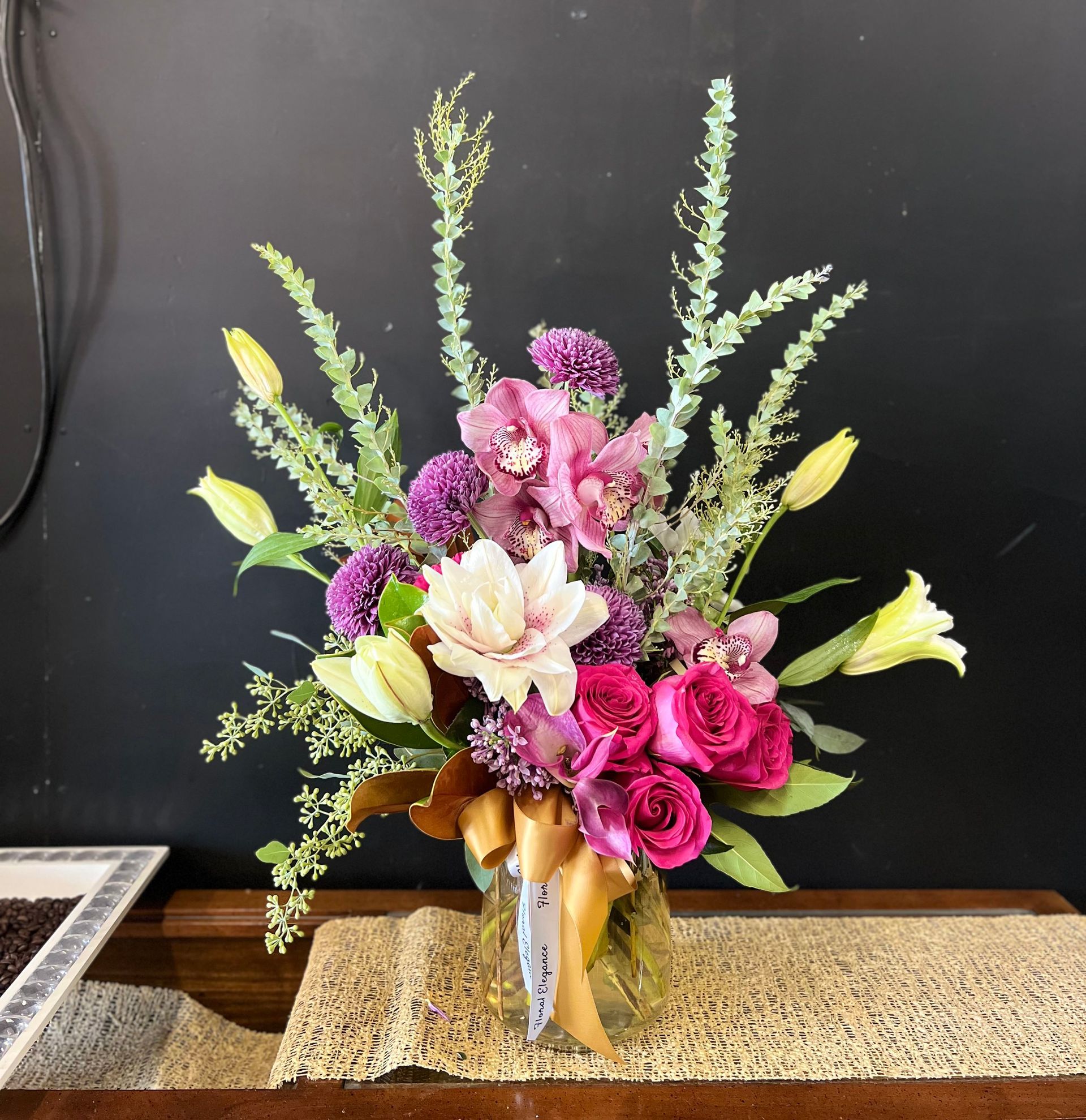 A vase filled with pink and purple flowers on a table