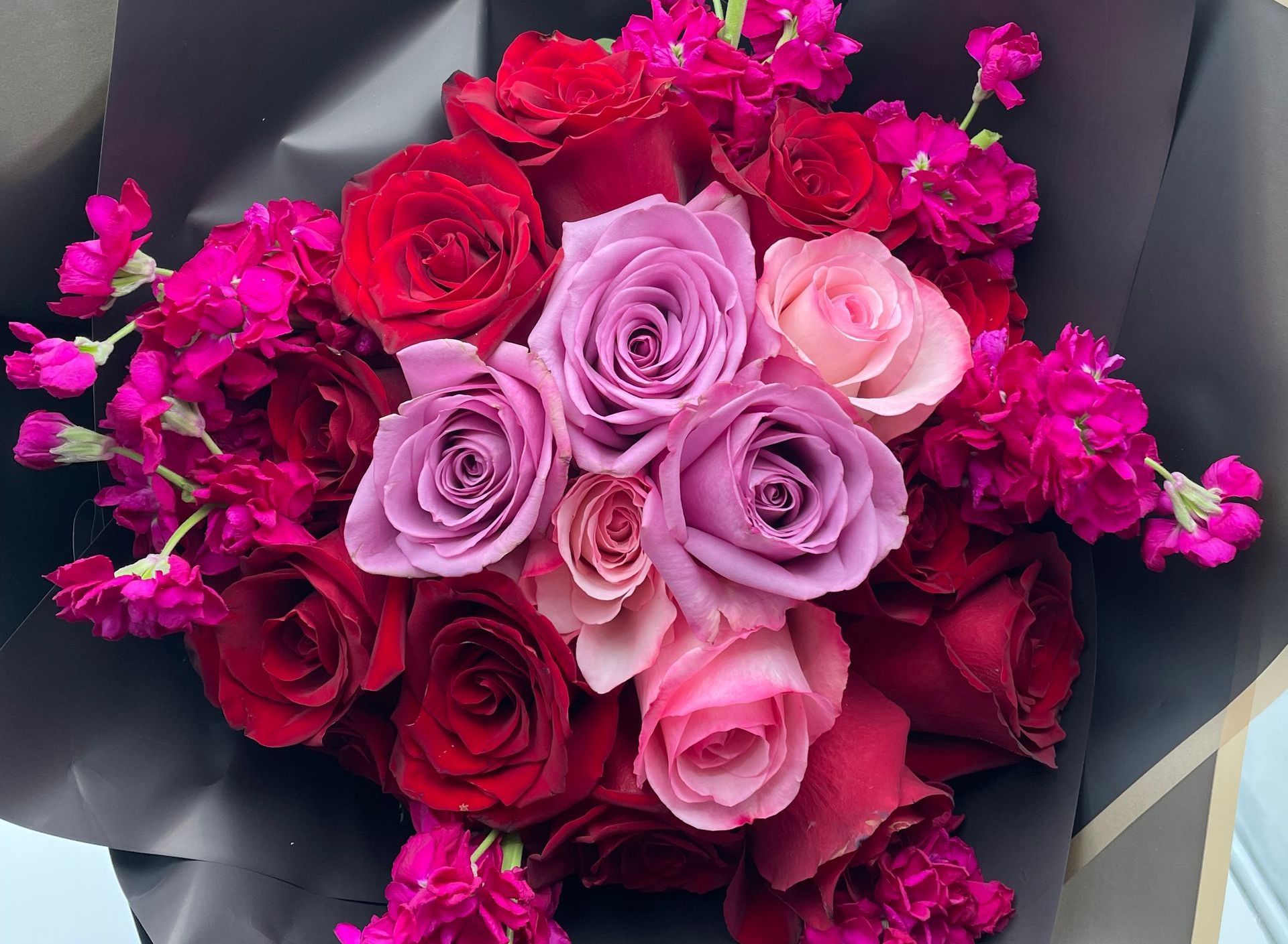 A coffin is decorated with flowers and baby 's breath.