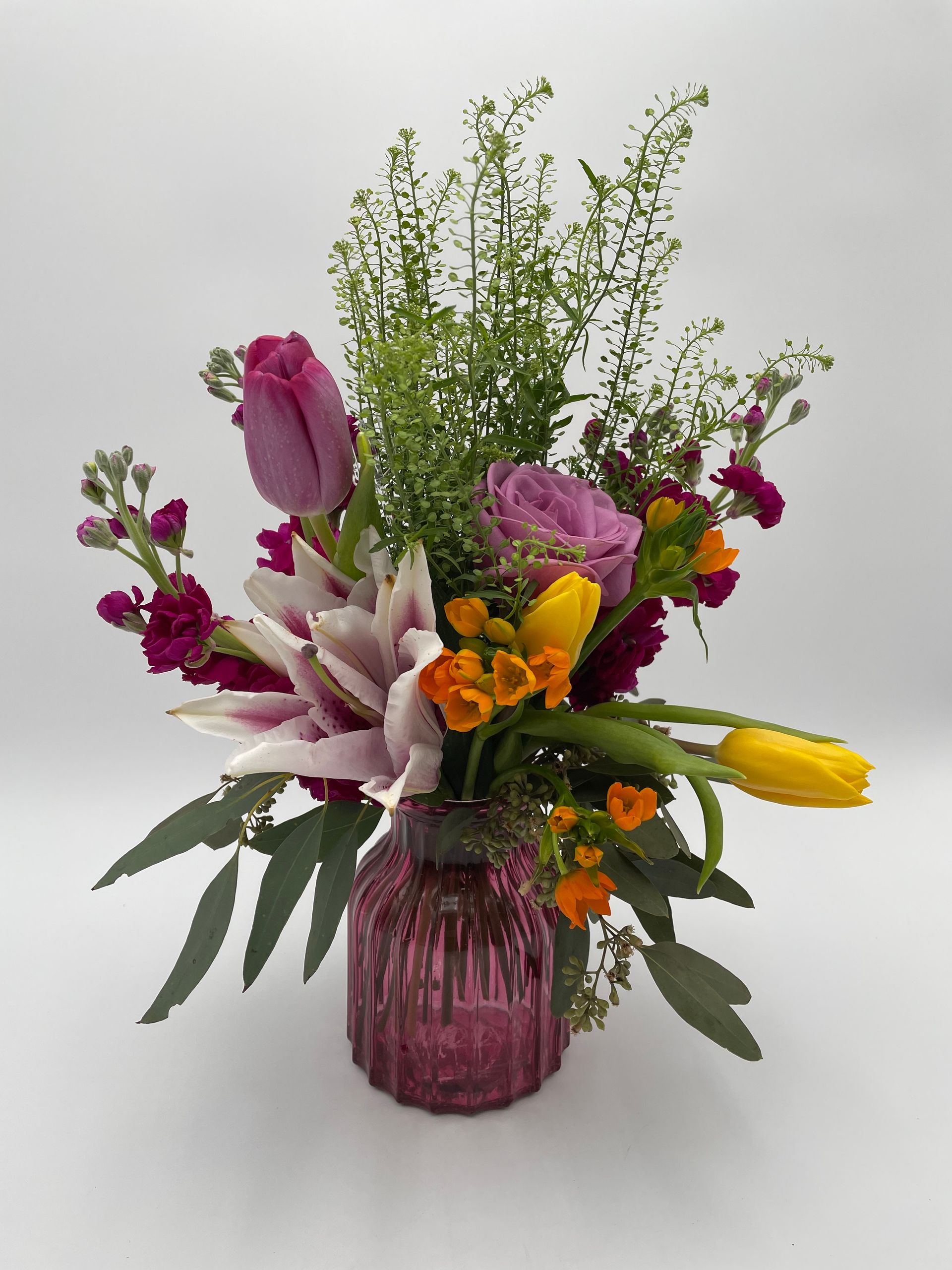 A vase filled with flowers on a white surface