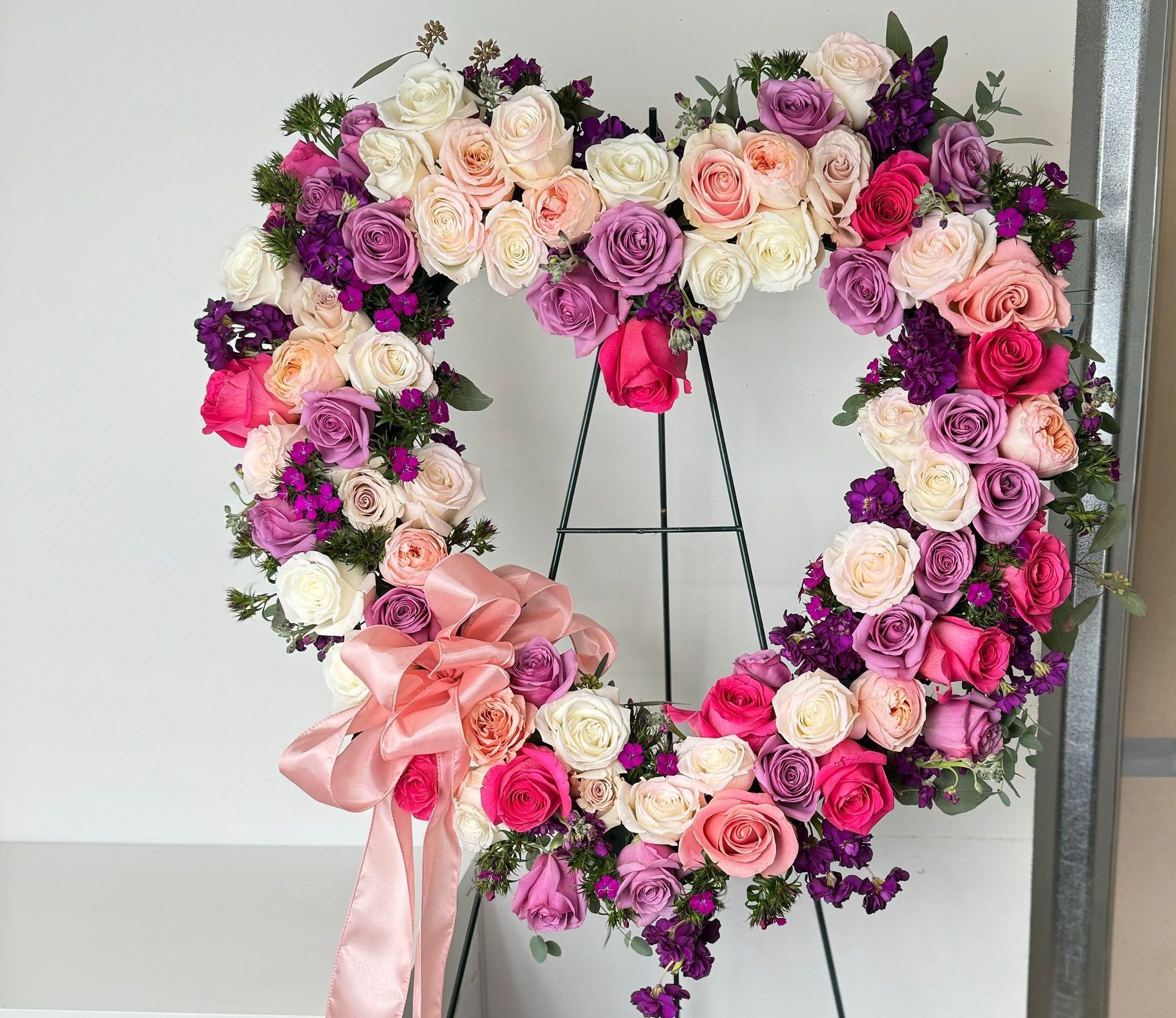 A coffin is decorated with flowers and baby 's breath.