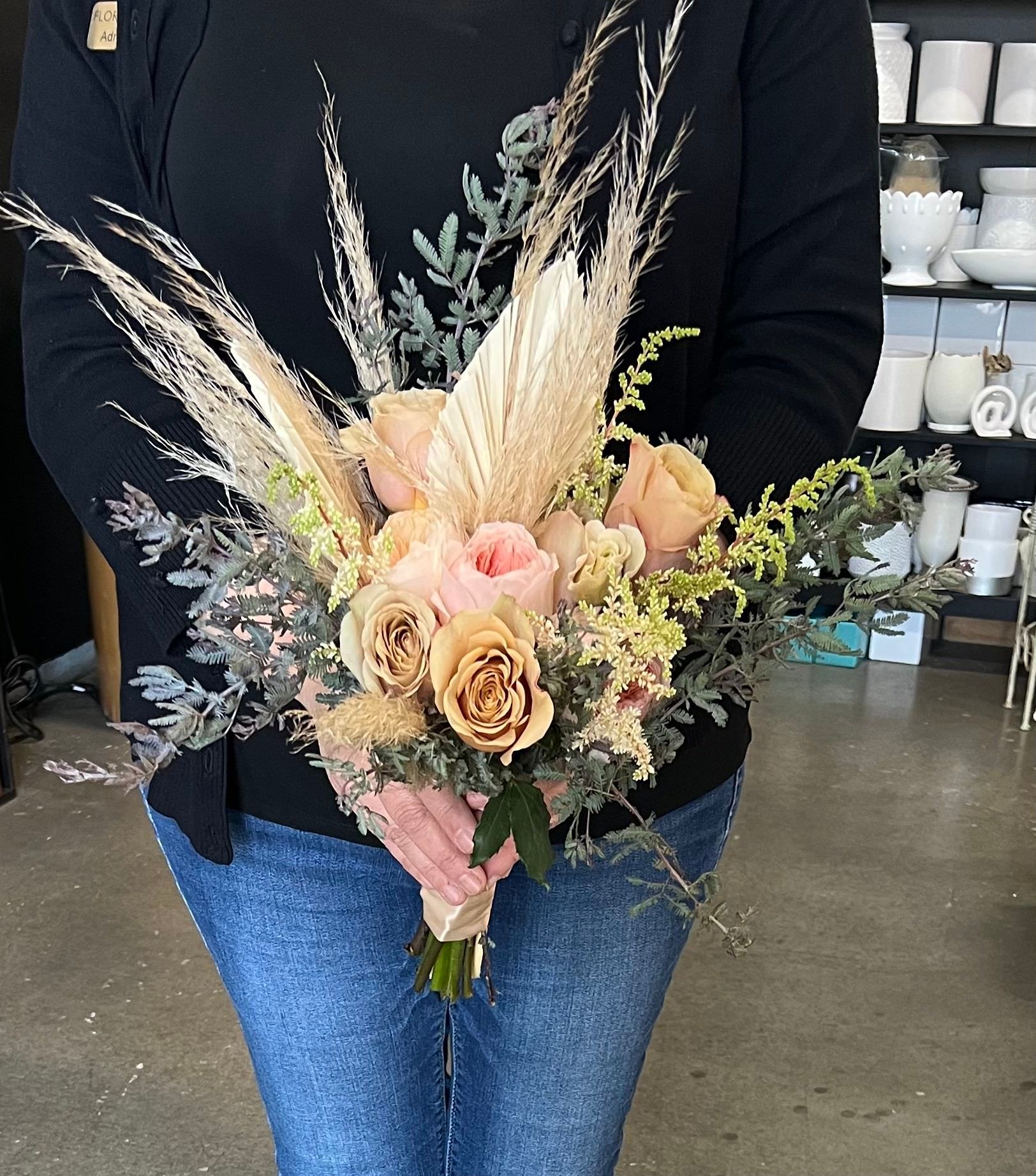 A woman is holding a bouquet of flowers in her hands.