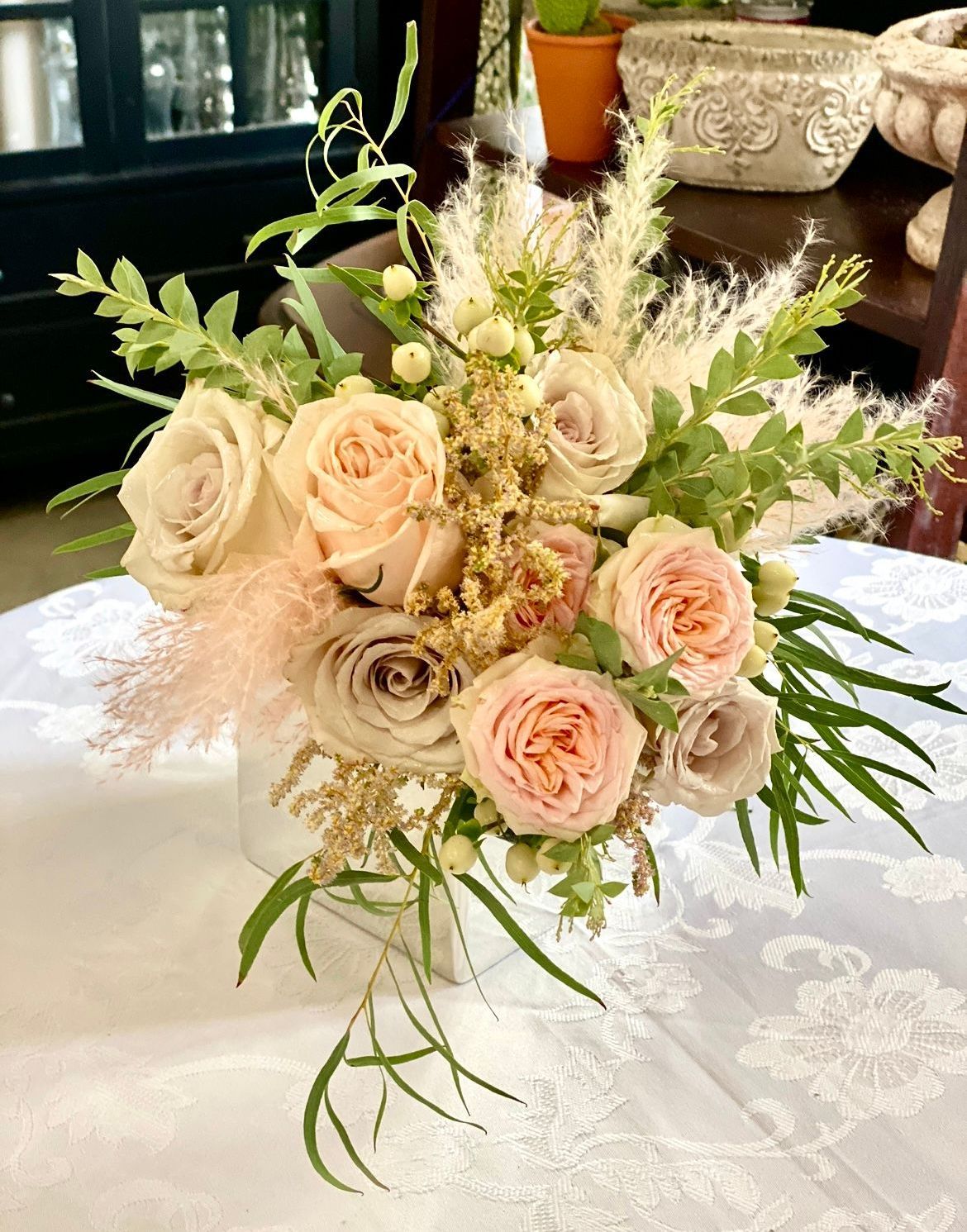 A vase filled with flowers is sitting on a table.